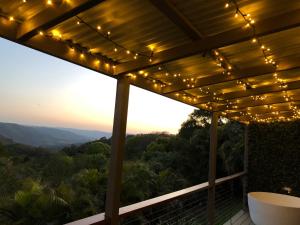 a patio with a string of lights on it at Maleny Luxury Cottages in Maleny