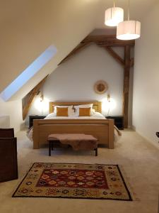 a bedroom with a large bed in an attic at Les 7 Tilleuls - Chambres d'hôtes in Mesland