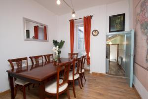 a dining room with a wooden table and chairs at 7 Bedroom Townhouse in Edinburgh