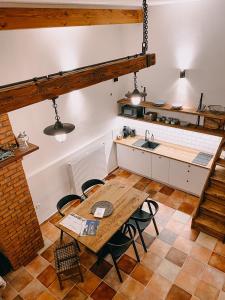a kitchen and dining room with a wooden table and chairs at Apartmány Na Špejcharu in Stříbřec