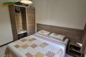 sypialnia z łóżkiem z kołdrą w obiekcie Flat no bosque da praia Pipa-RN w mieście Pipa