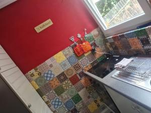 a kitchen with a tiled counter and a sink at Megi in Esslingen