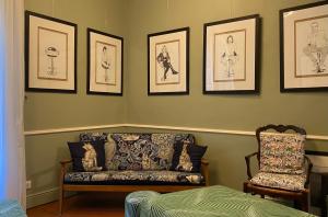 a living room with a couch and pictures on the wall at Hotel Central Bastia in Bastia