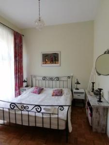 a bedroom with a bed and a table and a window at Vila Rogashka One Bedroom Apartment in Rogaška Slatina