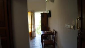 a hallway with a table and a door to a room at Nalla Eco Beach Resort in Pondicherry