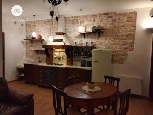 a kitchen with a table and a kitchen with a stove at DonMattè - Charme & Rooms in Conversano