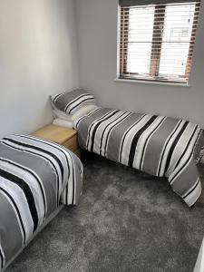 two beds sitting next to each other in a room at Burry Port Harbour Apartment in Burry Port