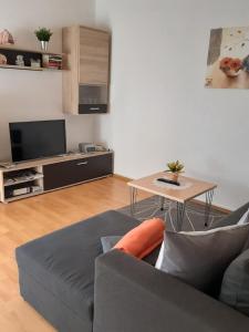 a living room with a couch and a table at Ferienwohnungen Malz in Blaibach
