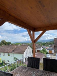 a balcony with chairs and a view of a city at FeWo Weitblick in Singen