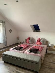 a bedroom with two beds with pink comforters at FeWo Weitblick in Singen