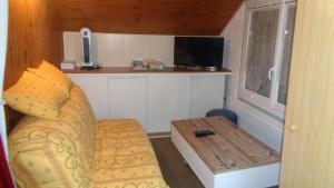a small room with a couch and a table at NANA 63 in La Bourboule
