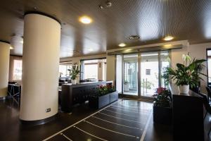 a lobby with plants and a column in a building at Abruzzo Marina Hotel - Family & Beach Resort in Silvi Marina +99 photos