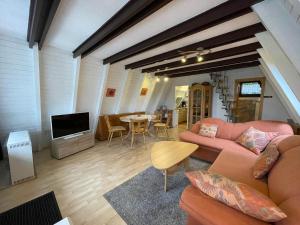 a living room with a couch and a tv and a table at Ferienhäuser 6 & 24 in Freyung