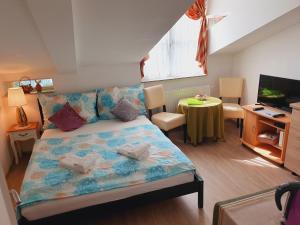 A bed or beds in a room at Karmelita Boutique Apartman