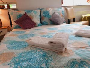 A bed or beds in a room at Karmelita Boutique Apartman