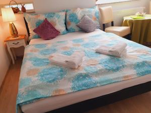 A bed or beds in a room at Karmelita Boutique Apartman