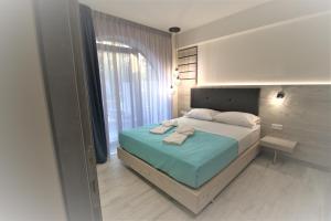 a bedroom with a bed and a large window at The Palms novasithonia in Vourvourou
