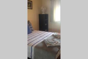 a bedroom with a bed with towels on it at T2 Sanguinaires calme et cosy, entre mer et maquis in Ajaccio