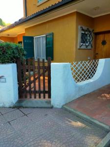 einen Zaun vor einem Haus in der Unterkunft Amazing & Relaxing Villa by the sea with large garden in Santa Liberata