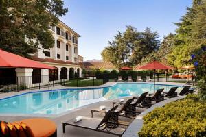a pool at a hotel with chairs and umbrellas at Hyatt Regency Westlake in Westlake Village