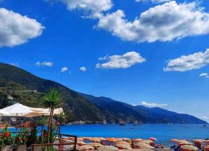 a view of a beach with chairs and the water at La Casa Del Borgo in Beverino
