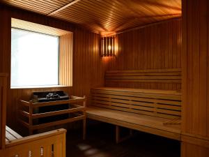 
a room with a wooden floor and wooden walls at Golden Tulip Amnéville in Amnéville
