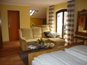 a living room with a couch and a table at Landhaus Strangmüller in Bad Füssing