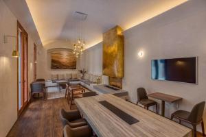 a living room with a table and some chairs at Cantera 1910 Hotel Boutique, Destination Hotel in San Miguel de Allende