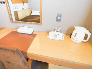 Postel nebo postele na pokoji v ubytování Castle Inn Sendai