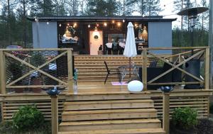 a house with a deck and a bar at Tallbacken Fritidsby in Brännan