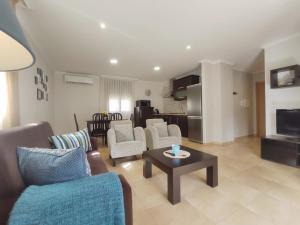 a living room with a couch and chairs and a table at Apartamentos El Valle in Bubaces