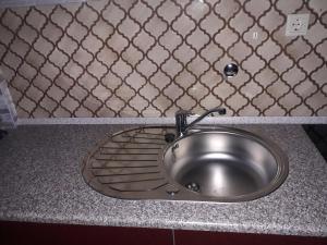 a stainless steel sink in a kitchen counter at Ferienwohnung Bruni in Birresborn