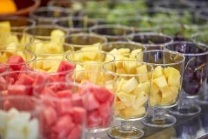a row of wine glasses filled with fruit on a table at Nura Santa Ponsa & Spa in Santa Ponsa