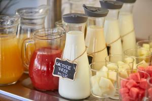 a bunch of different types of milk and fruit at Nura Santa Ponsa & Spa in Santa Ponsa