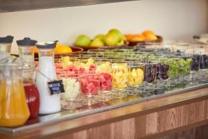 a buffet with many different types of fruit in glasses at Nura Santa Ponsa & Spa in Santa Ponsa