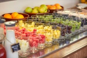 a buffet filled with glasses of fruit on a counter at Nura Santa Ponsa & Spa in Santa Ponsa