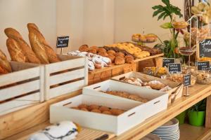 a bakery with lots of different types of bread at Nura Santa Ponsa & Spa in Santa Ponsa