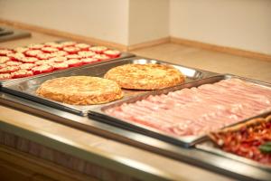 a buffet line with many different types of food at Nura Santa Ponsa & Spa in Santa Ponsa