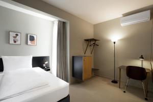 Un pat sau paturi într-o cameră la Nordic Hotel Lagos