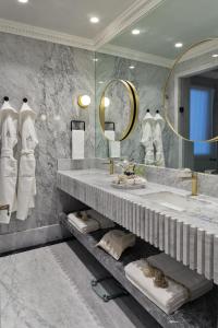 a bathroom with two sinks and a large mirror at The Alest Hotel in Mexico City