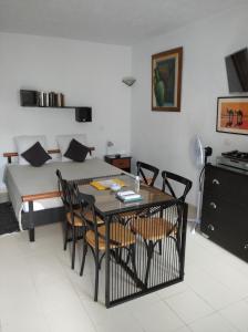 a room with a table and chairs and a bed at STUDIO AU COEUR de CARTHAGE HANNIBAL in Carthage