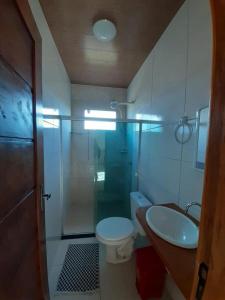 a bathroom with a shower and a toilet and a sink at Village Taipu de Fora in Marau