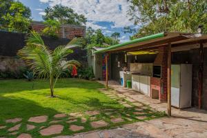 a house with a palm tree in the yard at Village Brasil, Lençóis in Lençóis