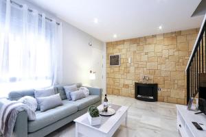 a living room with a couch and a fireplace at Little LIBERTAD Heart of Cadiz Grupo AC Gestion in Cádiz