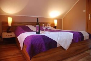 a bedroom with a bed with two glasses of wine at Pokoje Gościnne u Anety in Wicko