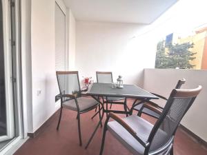 a black table and chairs on a balcony at Residential apartment in Split