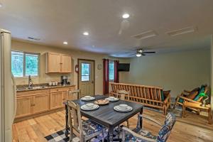a kitchen and dining room with a table and chairs at Cozy and Secluded Cabin - 4 Mi to Glacier Natl Park in West Glacier