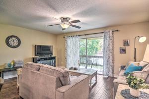 a living room with a couch and a tv at Sarasota Escape about 4 Mi to Siesta Key Beach! in Sarasota