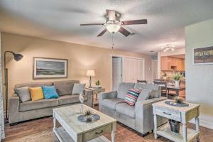 a living room with two couches and a ceiling fan at Sarasota Escape about 4 Mi to Siesta Key Beach! in Sarasota