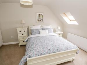 a white bedroom with a bed and a window at Curragh Hill in Westport